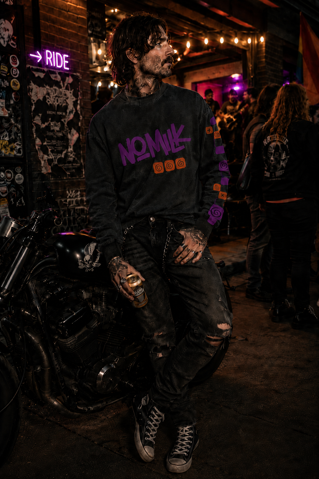 Person wearing a black sweatshirt with 'Nomik' branding in a dark, indoor setting.